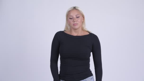 Young serious blonde woman thinking and looking down — Stock Video