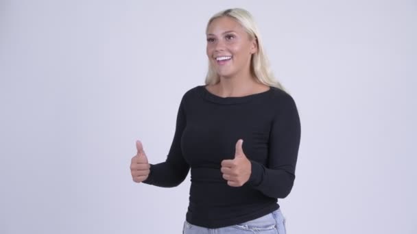 Young happy blonde woman looking excited while giving thumbs up — Stock Video