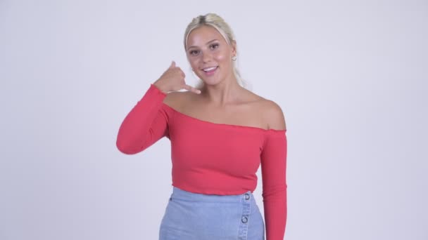 Happy young beautiful blonde woman with call me gesture — Stock Video