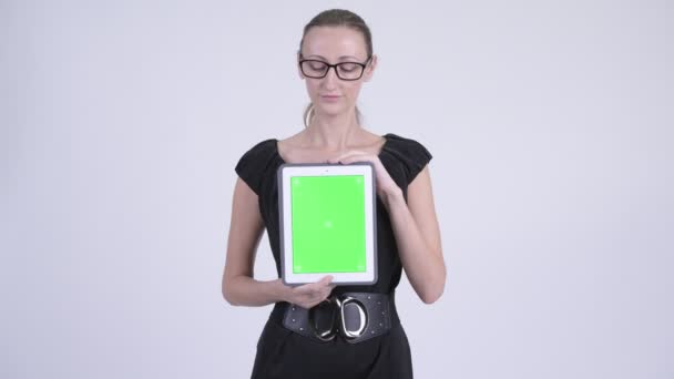 Happy blonde businesswoman thinking while showing digital tablet — Stock Video