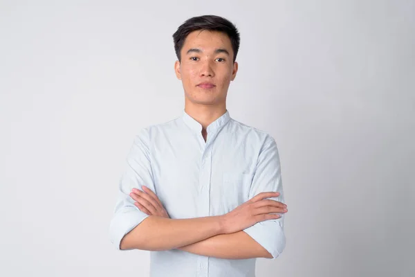 Porträtt av ung Vacker asiatisk affärsman med armarna korsade — Stockfoto