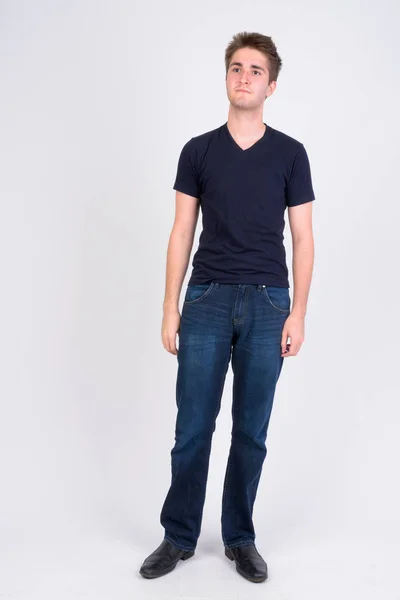Full body shot of young handsome man thinking — Stock Photo, Image