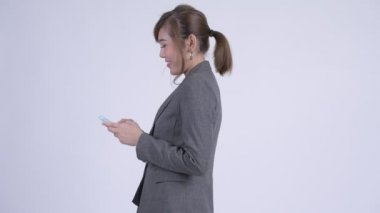 Genç Asyalı işkadını elinden alınan telefon ile profil görünümü