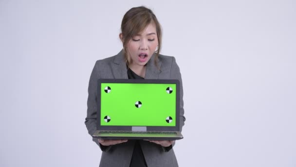 Young happy Asian businesswoman showing laptop and looking surprised — Stock Video