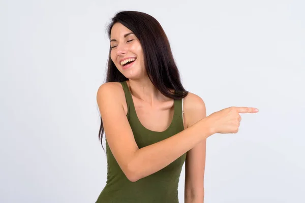 Retrato de feliz jovem bela mulher rindo e apontando o dedo — Fotografia de Stock