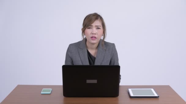 Young stressed Asian businesswoman getting headache at work — Stock Video