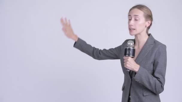 Jonge gelukkig blond zakenvrouw als nieuwslezer presenteren iets — Stockvideo