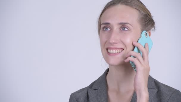 Face of happy young blonde businesswoman talking on the phone — Stock Video