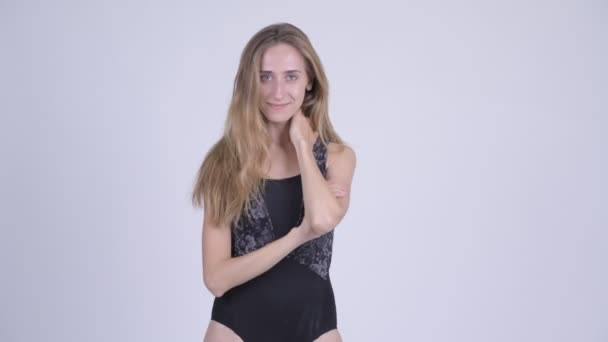 Happy young blonde woman in swimsuit posing with arms crossed — Stock Video