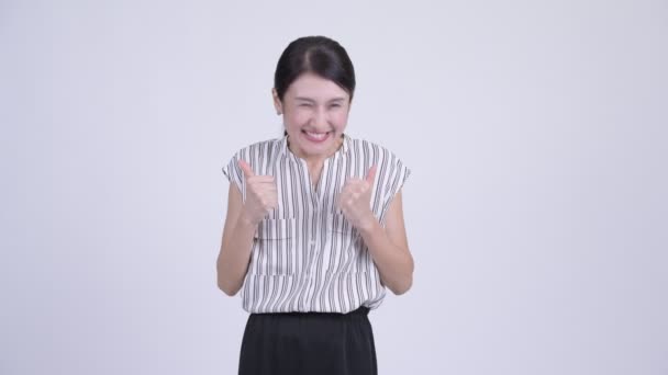 Happy beautiful Asian businesswoman looking excited while giving thumbs up — Stock Video