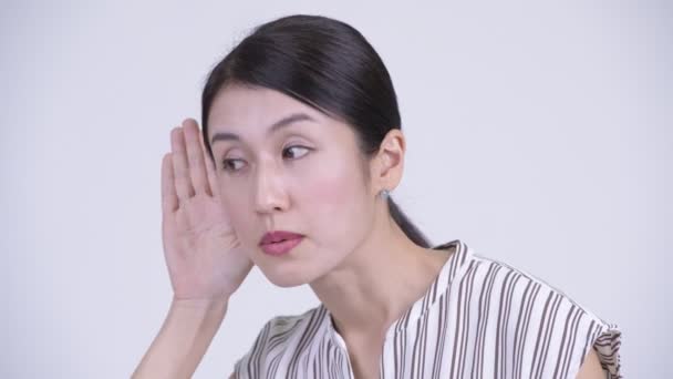 Face of happy beautiful Asian businesswoman thinking and listening — Stock Video