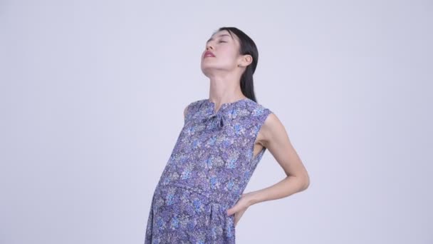 Stressed pregnant Asian woman having back pain — Stock Video