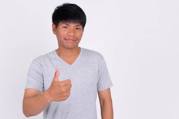 Portré fiatal ázsiai férfi felemeli a hüvelykujját — Stock Fotó