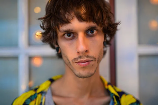 Face of young rebellious man looking at camera outdoors — Stock Photo, Image