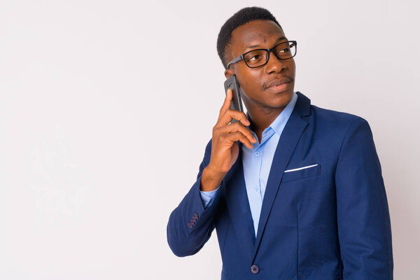 Studio shot of young handsome African businessman with Afro hair against white background