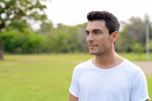 Rostro de joven guapo hispano pensando en el parque — Foto de Stock