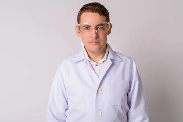 Portrait of handsome man doctor wearing protective glasses — Stock Photo, Image