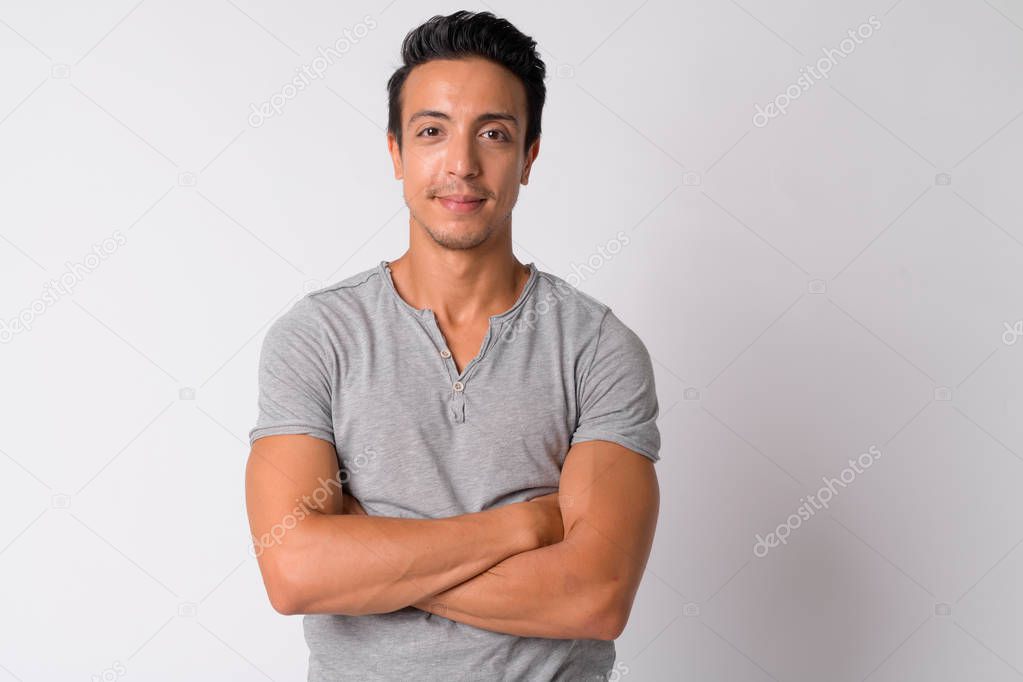 Portrait of handsome Hispanic man with arms crossed
