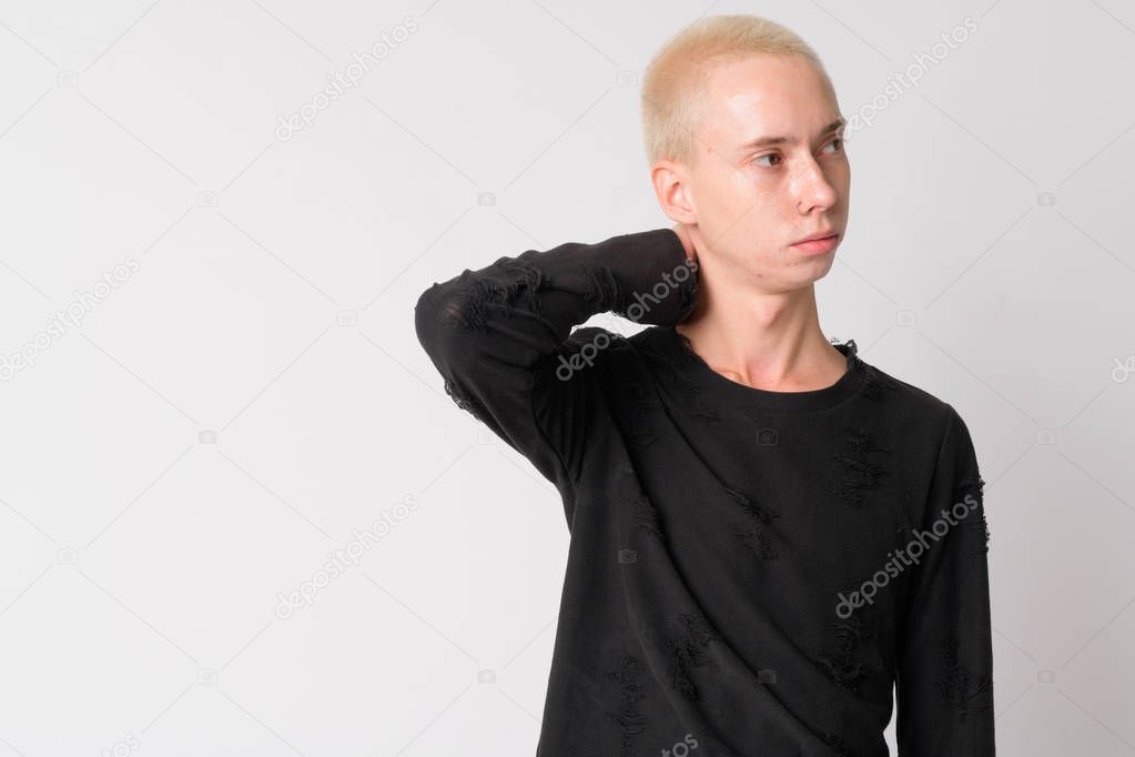 Portrait of young handsome androgynous man thinking