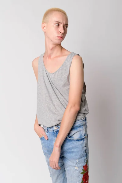Portrait of young androgynous man thinking and looking back — Stock Photo, Image