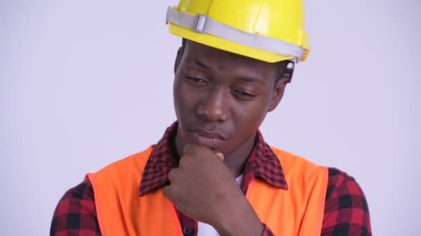 Face of young stressed African man construction worker thinking — Stock Video