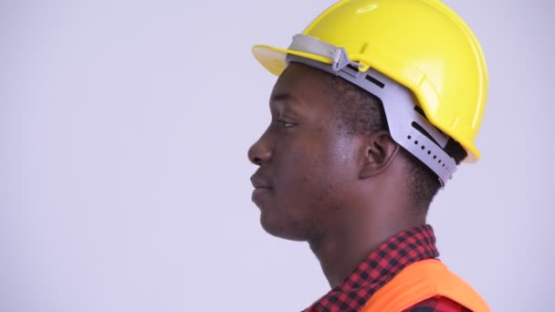 Gros plan profil vue de heureux jeune homme africain travailleur de la construction souriant — Video