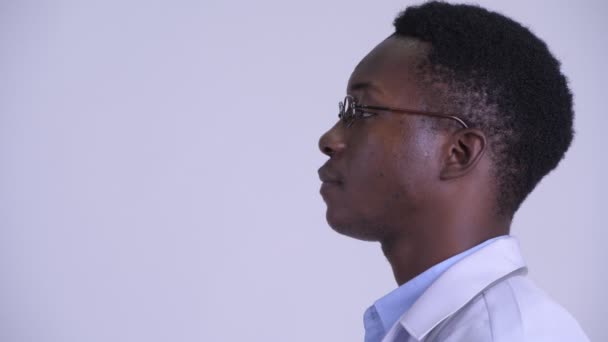 Closeup profile view of young handsome African man doctor with eyeglasses — Stock Video