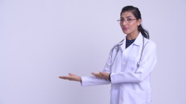 Young happy Persian woman doctor showing something — Stock Video