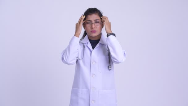 Young stressed Persian woman doctor having headache — Stock Video