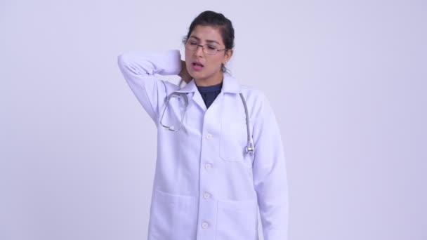 Young stressed Persian woman doctor having neck pain — Stock Video