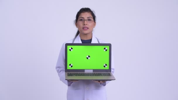 Açıklayan ve dizüstü bilgisayarı gösteren genç mutlu İranlı kadın doktor — Stok video