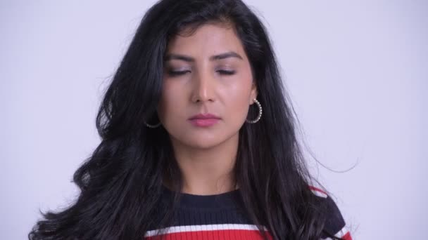 Face of young beautiful Persian woman showing hear no evil concept — Stock Video