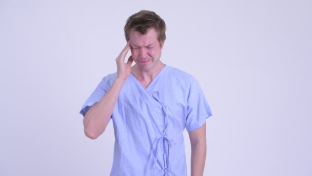 Portrait of young stressed man patient having headache — Stock Video