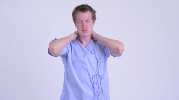 Portrait of young stressed man patient having neck pain — Stock Video