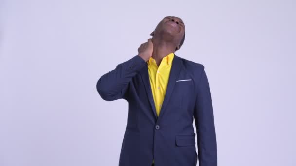 Young stressed African businessman having neck pain — Stock Video