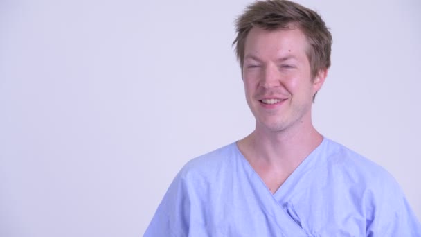 Gezicht van gelukkig jongeman patiënt glimlachend en denken — Stockvideo