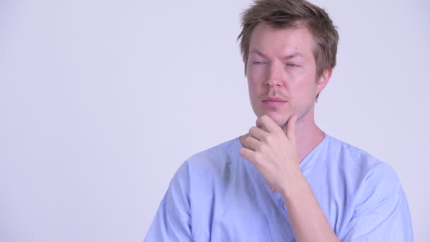 Face of happy young man patient thinking and looking up — Stock Video