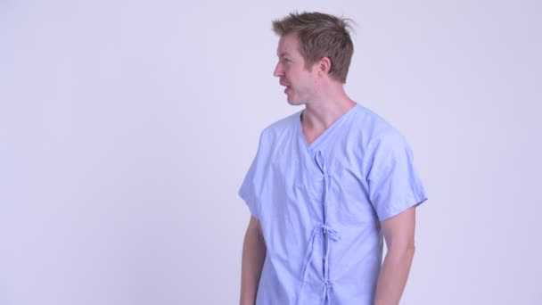 Profile view of young man patient refusing and showing stop gesture — Stock Video