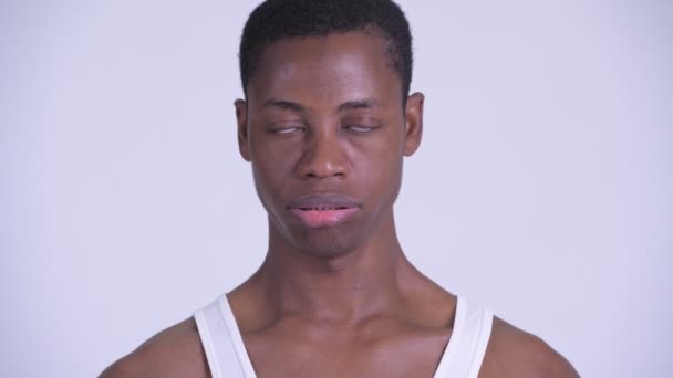 Face of young stressed African man looking bored and tired — Stock Video