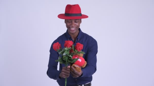 Young happy African businessman giving gifts ready for Valentines day — Stock Video