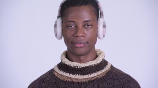 Face of young happy African man smiling ready for winter — Stock Video