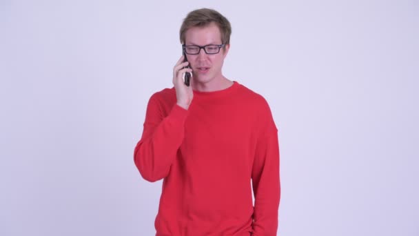 Happy young handsome man talking on the phone — Stock Video