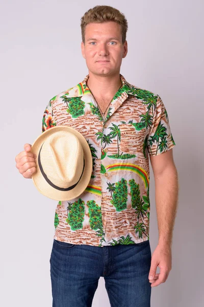 Portrait of young blonde tourist man holding hat — Stock Photo, Image