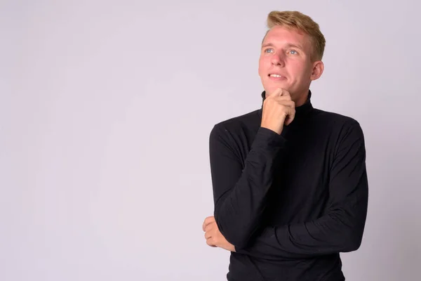 Portrait of happy young blonde man thinking — Stock Photo, Image