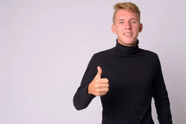 Portrait of happy young blonde man giving thumbs up — Stock Photo, Image