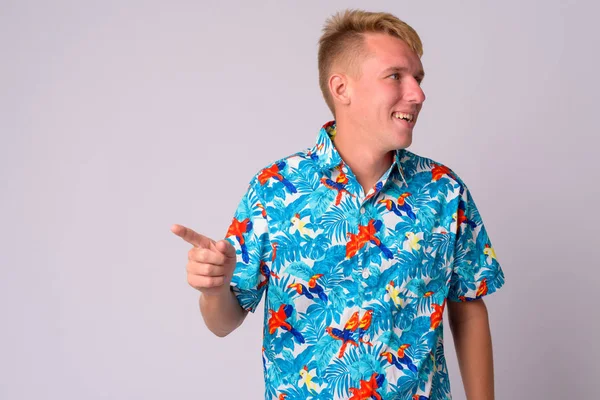 Happy young blonde tourist man laughing and looking away — Stock Photo, Image