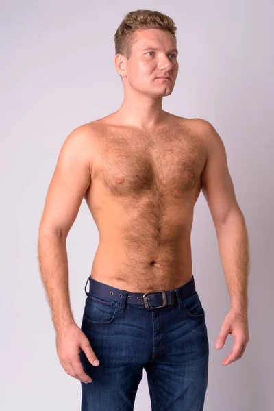 Portrait of young blonde shirtless man with chest hair thinking — Stock Photo, Image