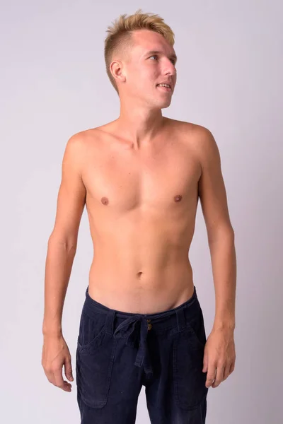 Portrait of happy young blonde man thinking shirtless — Stock Photo, Image