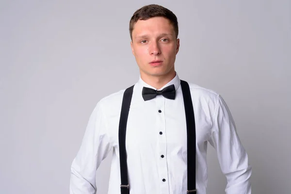 Portrait of young businessman with suspenders looking at camera — Stock Photo, Image