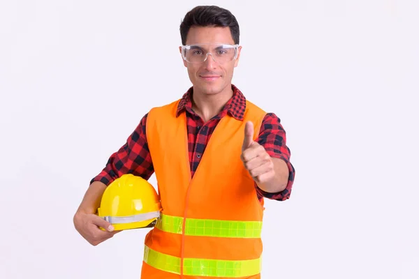 Giovane bello ispanico uomo costruzione lavoratore dando pollici in su — Foto Stock